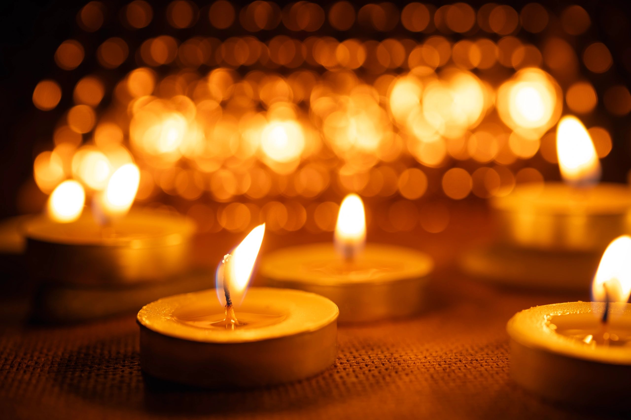 Lit candles with soft bokeh background