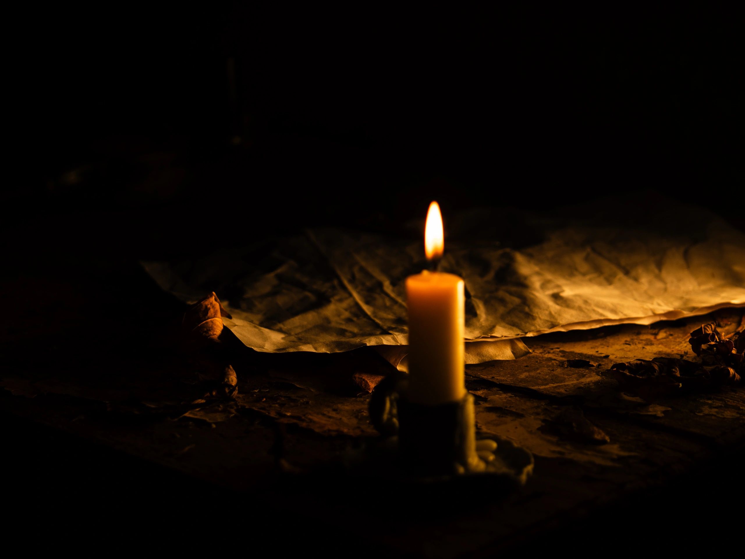 Candlelight illuminating a page, evoking evening prayer